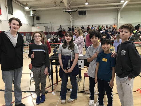Students pose at a robotics competition.